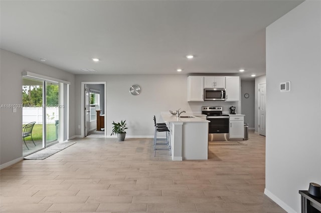 3021 June Cir Fl, LaBelle, FL 33935 - kitchen with appliances with stainless steel finishes, baseboards, white cabinetry, a sink, and light countertops