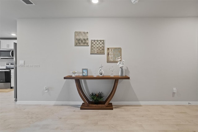 3021 June Cir Fl, LaBelle, FL 33935 - detailed view of stainless steel appliances, wood finished floors, recessed lighting, and baseboards