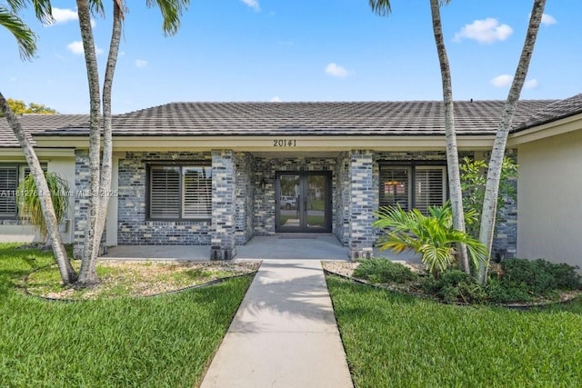 20141 NW 8th St, Pembroke Pines, FL 33029 - view of exterior entry with french doors and a lawn