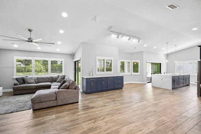 20141 NW 8th St, Pembroke Pines, FL 33029 - living room featuring healthy amount of natural light, a textured ceiling, light wood-style flooring, baseboards, and recessed lighting