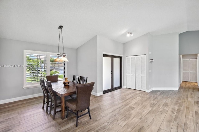 20141 NW 8th St, Pembroke Pines, FL 33029 - dining area featuring baseboards, lofted ceiling, and light wood-style flooring