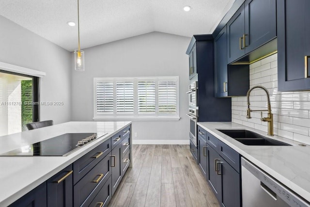 20141 NW 8th St, Pembroke Pines, FL 33029 - kitchen with appliances with stainless steel finishes, a sink, lofted ceiling, decorative backsplash, and light wood finished floors