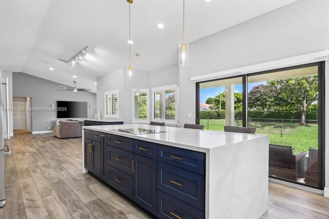 20141 NW 8th St, Pembroke Pines, FL 33029 - kitchen featuring light countertops, open floor plan, light wood-type flooring, lofted ceiling, and black electric stovetop