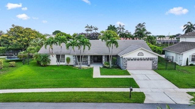 20141 NW 8th St, Pembroke Pines, FL 33029 - ranch-style house featuring a trampoline, an attached garage, stone siding, driveway, and stucco siding