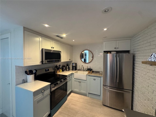 5161 Collins Ave Unit 315, Miami Beach, FL 33140 - kitchen featuring appliances with stainless steel finishes, decorative backsplash, light countertops, and recessed lighting