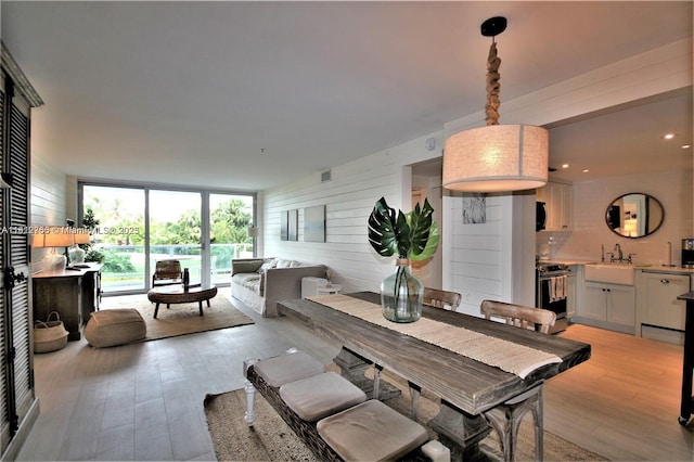5161 Collins Ave Unit 315, Miami Beach, FL 33140 - dining space with light wood finished floors, wood walls, and recessed lighting