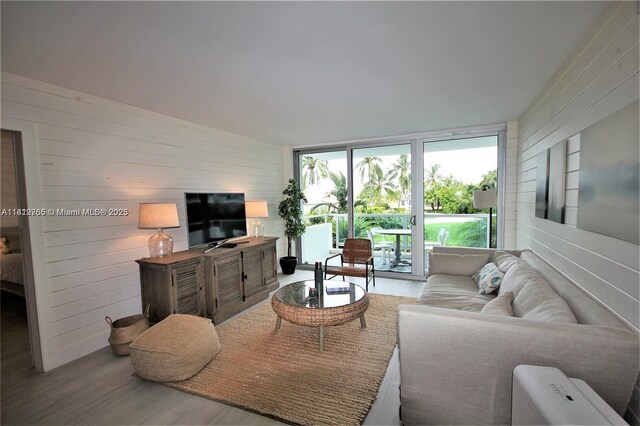 5161 Collins Ave Unit 315, Miami Beach, FL 33140 - living room with wooden walls and wood finished floors