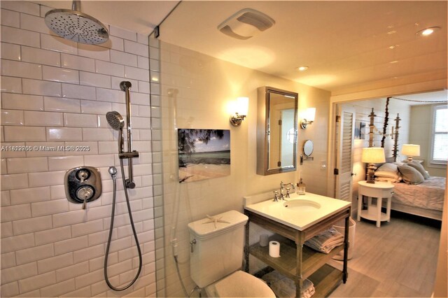 5161 Collins Ave Unit 315, Miami Beach, FL 33140 - ensuite bathroom with tiled shower, vanity, wood finished floors, and recessed lighting