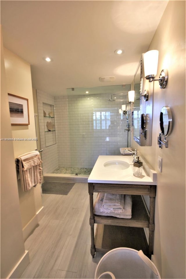 5161 Collins Ave Unit 315, Miami Beach, FL 33140 - bathroom featuring vanity, a walk in shower, wood finished floors, and recessed lighting