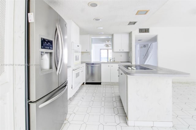 1006 NE 24th Ave Unit 190, Hallandale Beach, FL 33009 - kitchen featuring stainless steel appliances, a sink, white cabinetry, light countertops, and light floors