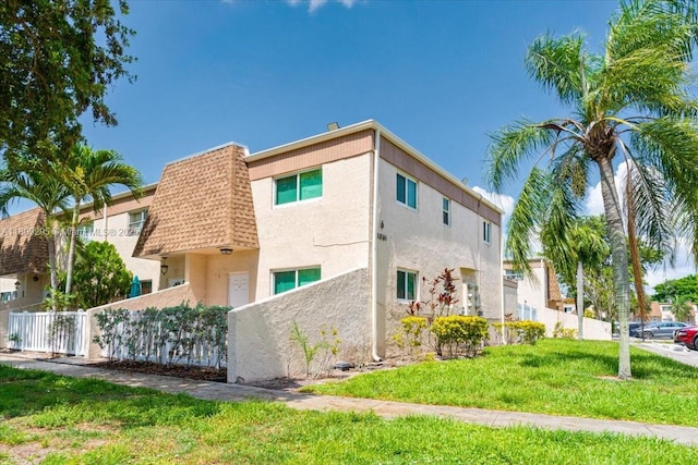 1061 NW 80th Ave Unit J, Margate, FL 33063 - view of side of home with stucco siding, mansard roof, and roof with shingles