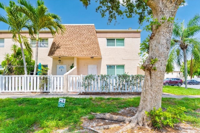 1061 NW 80th Ave Unit J, Margate, FL 33063 - view of property with roof with shingles, stucco siding, and mansard roof