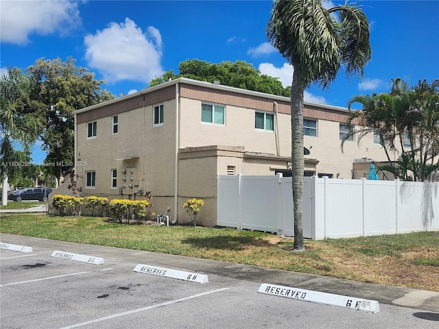 1061 NW 80th Ave Unit J, Margate, FL 33063 - view of side of property featuring uncovered parking and stucco siding