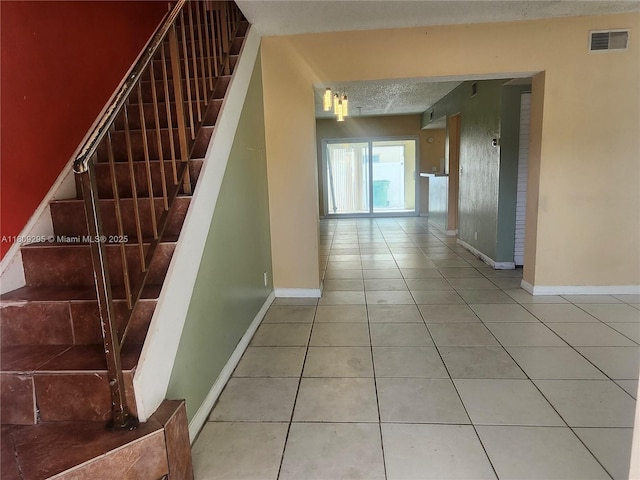 1061 NW 80th Ave Unit J, Margate, FL 33063 - stairs featuring tile patterned floors and a textured ceiling