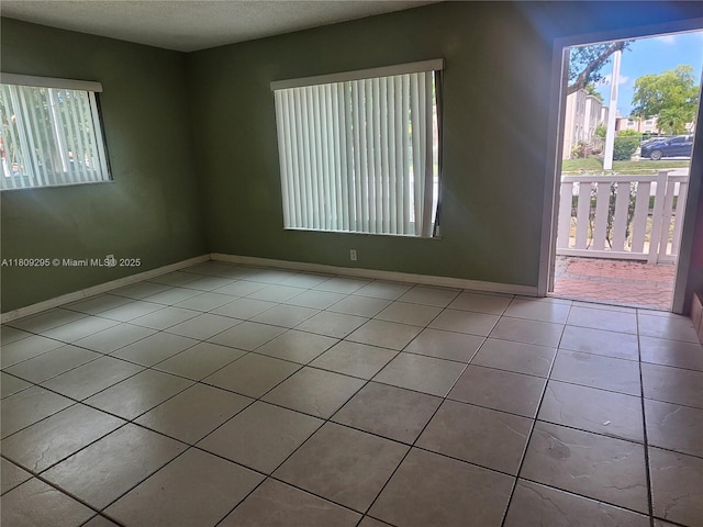 1061 NW 80th Ave Unit J, Margate, FL 33063 - spare room with tile patterned floors and a textured ceiling