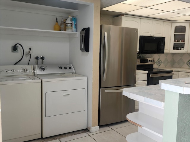 1061 NW 80th Ave Unit J, Margate, FL 33063 - laundry room with washer and clothes dryer and light tile patterned floors