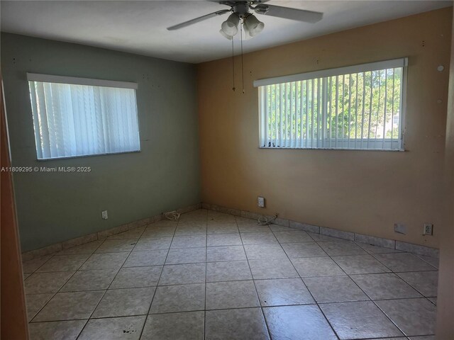 1061 NW 80th Ave Unit J, Margate, FL 33063 - tiled spare room featuring ceiling fan and baseboards