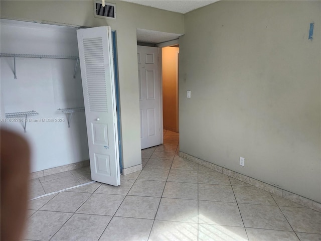 1061 NW 80th Ave Unit J, Margate, FL 33063 - unfurnished bedroom with light tile patterned floors and a closet