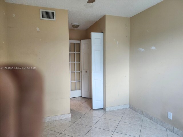 1061 NW 80th Ave Unit J, Margate, FL 33063 - empty room featuring light tile patterned floors and a textured ceiling