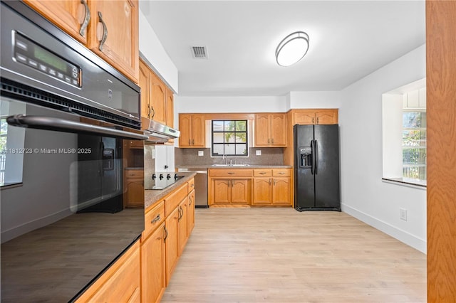18801 NW 29th Ct, Miami Gardens, FL 33056 - kitchen featuring black appliances, light wood-type flooring, baseboards, light countertops, and a sink
