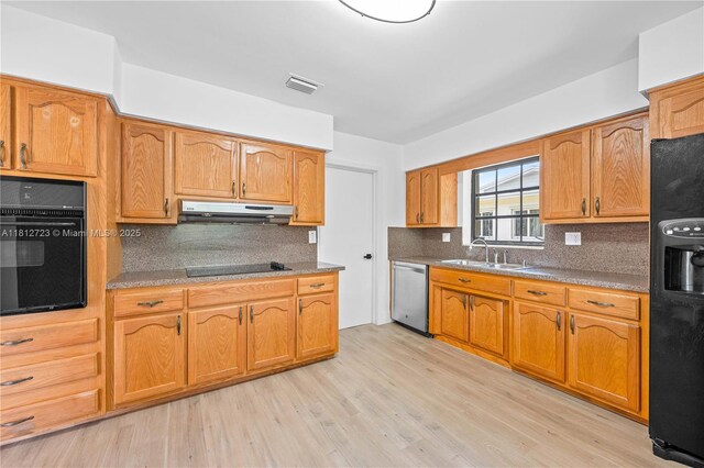 18801 NW 29th Ct, Miami Gardens, FL 33056 - kitchen featuring black appliances, under cabinet range hood, a sink, light wood finished floors, and backsplash