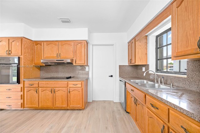 18801 NW 29th Ct, Miami Gardens, FL 33056 - kitchen featuring a sink, under cabinet range hood, black appliances, light wood-style floors, and tasteful backsplash