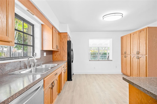 18801 NW 29th Ct, Miami Gardens, FL 33056 - kitchen featuring dishwasher, a sink, plenty of natural light, and light wood-style flooring