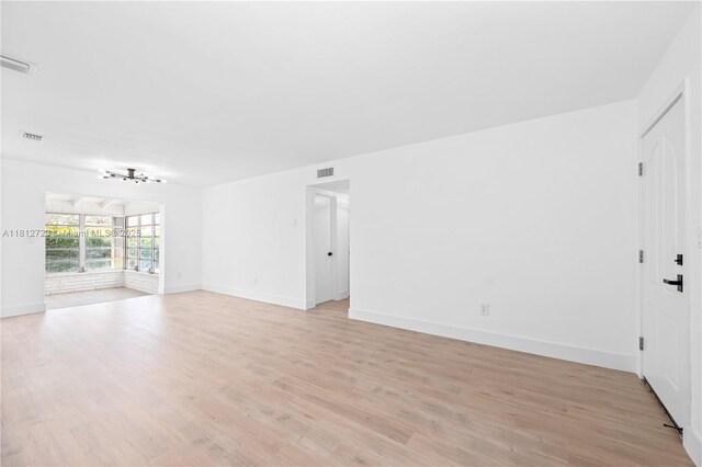 18801 NW 29th Ct, Miami Gardens, FL 33056 - unfurnished living room with light wood finished floors and baseboards