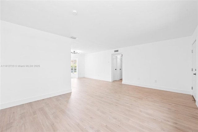 18801 NW 29th Ct, Miami Gardens, FL 33056 - unfurnished room with light wood-style flooring, baseboards, and a chandelier