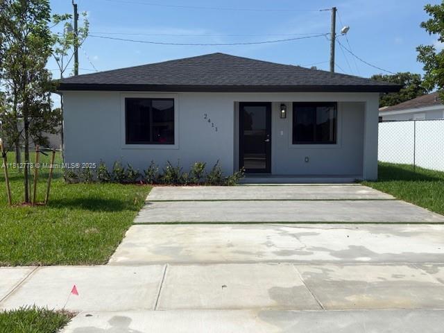 2411 NW 153rd St, Miami Gardens, FL 33054 - view of front of property with roof with shingles and stucco siding