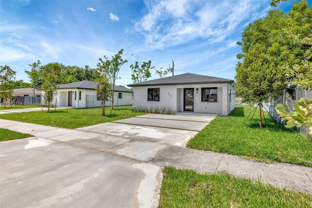 2411 NW 153rd St, Miami Gardens, FL 33054 - view of front facade featuring a front yard, stucco siding, and driveway