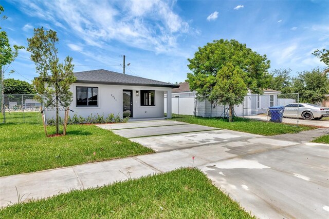 2411 NW 153rd St, Miami Gardens, FL 33054 - view of front of house with stucco siding, concrete driveway, and roof with shingles