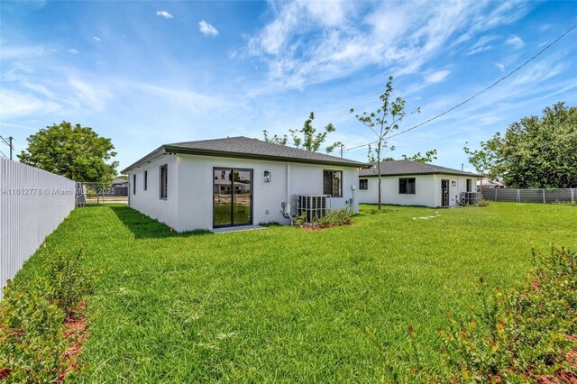 2411 NW 153rd St, Miami Gardens, FL 33054 - back of house featuring central AC unit and stucco siding