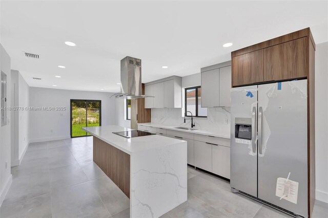 2411 NW 153rd St, Miami Gardens, FL 33054 - kitchen with stainless steel fridge with ice dispenser, island range hood, a sink, black electric stovetop, and modern cabinets