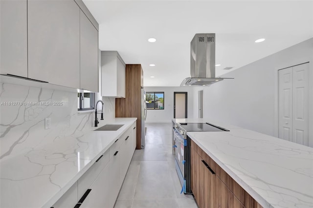 2411 NW 153rd St, Miami Gardens, FL 33054 - kitchen featuring modern cabinets, a sink, island exhaust hood, appliances with stainless steel finishes, and light stone counters