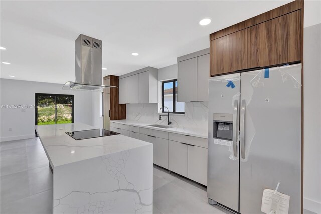 2411 NW 153rd St, Miami Gardens, FL 33054 - kitchen featuring stainless steel refrigerator with ice dispenser, island exhaust hood, a sink, black electric cooktop, and modern cabinets