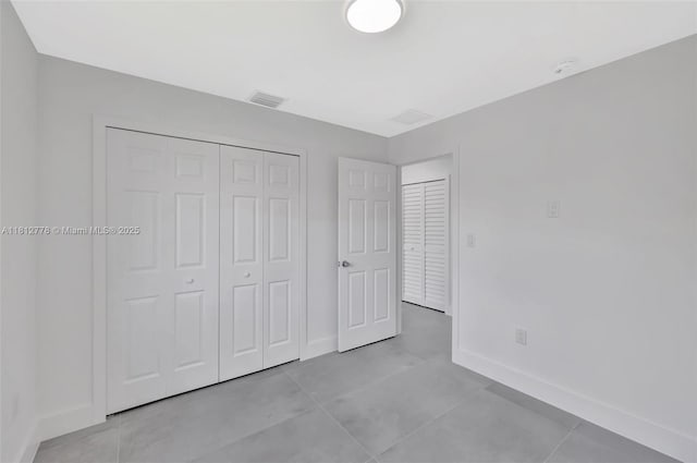 2411 NW 153rd St, Miami Gardens, FL 33054 - unfurnished bedroom featuring baseboards, a closet, and tile patterned floors