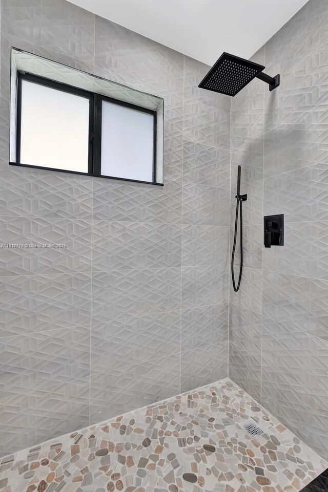 2411 NW 153rd St, Miami Gardens, FL 33054 - bathroom with a tile shower and stone finish flooring