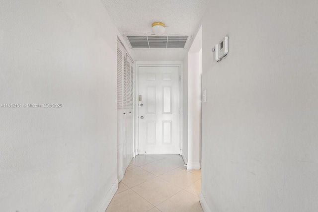 9235 SW 8th St Unit 502, Boca Raton, FL 33428 - hallway with baseboards, light tile patterned floors, and a textured ceiling