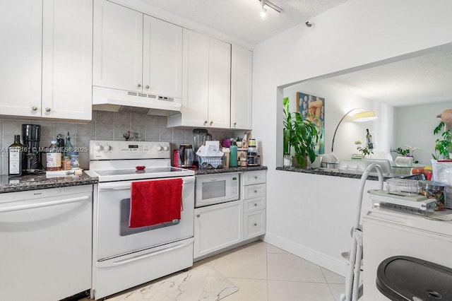 9235 SW 8th St Unit 502, Boca Raton, FL 33428 - kitchen with under cabinet range hood, white appliances, white cabinetry, a textured ceiling, and decorative backsplash