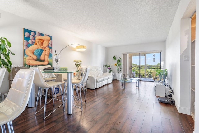 9235 SW 8th St Unit 502, Boca Raton, FL 33428 - dining space with wood finished floors and a textured ceiling