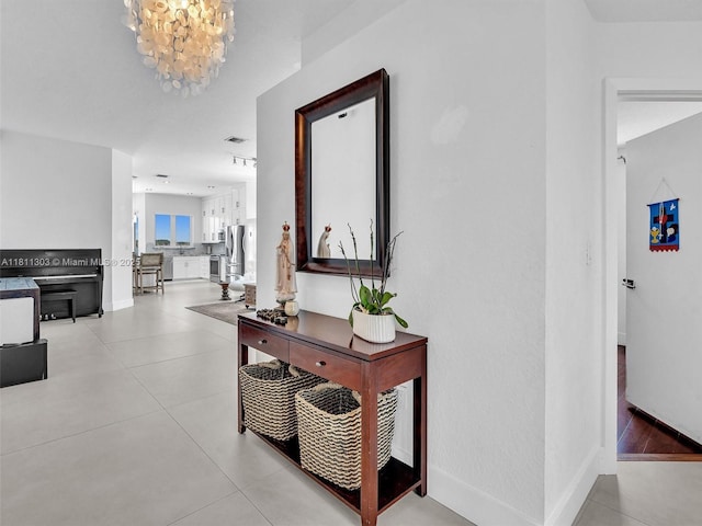 13381 SW 151st Ter, Miami, FL 33186 - hall featuring a chandelier and light tile patterned floors