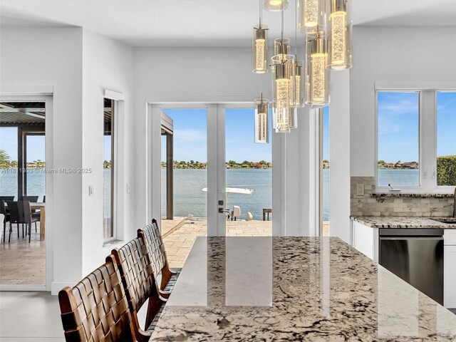 13381 SW 151st Ter, Miami, FL 33186 - dining room with french doors, a chandelier, plenty of natural light, and a water view