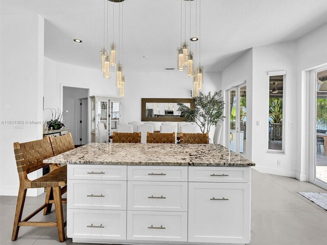 13381 SW 151st Ter, Miami, FL 33186 - kitchen with light stone countertops, white cabinetry, baseboards, and recessed lighting