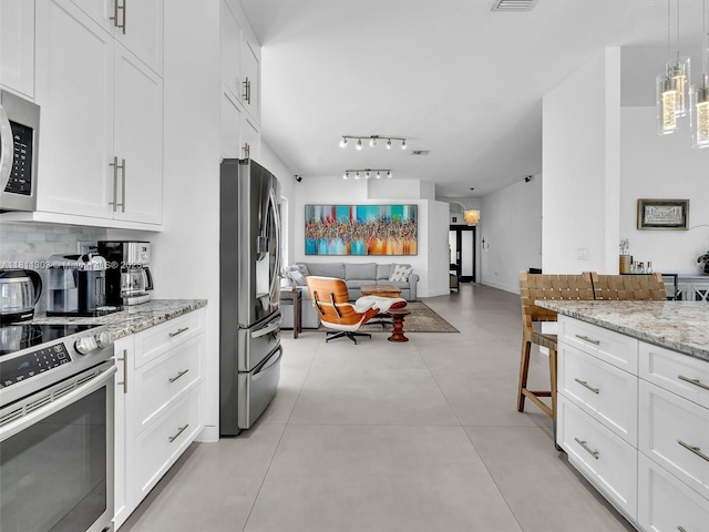 13381 SW 151st Ter, Miami, FL 33186 - kitchen featuring appliances with stainless steel finishes, open floor plan, and white cabinetry