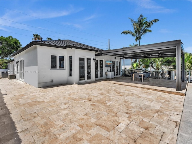 13381 SW 151st Ter, Miami, FL 33186 - back of property featuring french doors, a standing seam roof, a patio area, and stucco siding