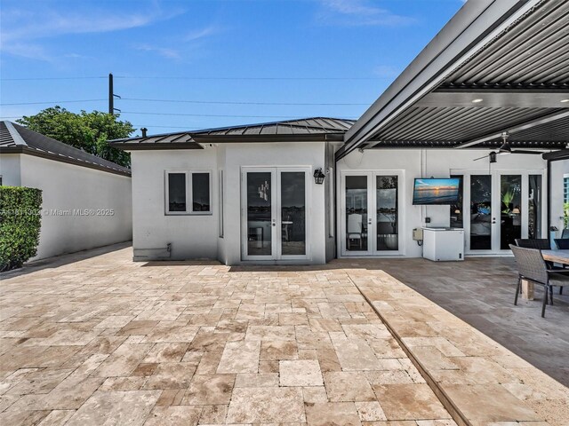 13381 SW 151st Ter, Miami, FL 33186 - rear view of house with french doors, a standing seam roof, metal roof, and stucco siding