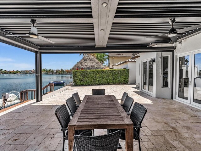 13381 SW 151st Ter, Miami, FL 33186 - view of patio featuring french doors, a water view, and outdoor dining area