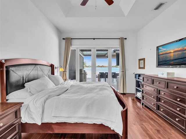 13381 SW 151st Ter, Miami, FL 33186 - bedroom with access to exterior, wood finished floors, a raised ceiling, and ceiling fan
