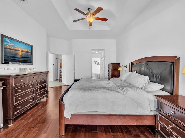 13381 SW 151st Ter, Miami, FL 33186 - bedroom featuring a tray ceiling, dark wood-type flooring, connected bathroom, and a ceiling fan
